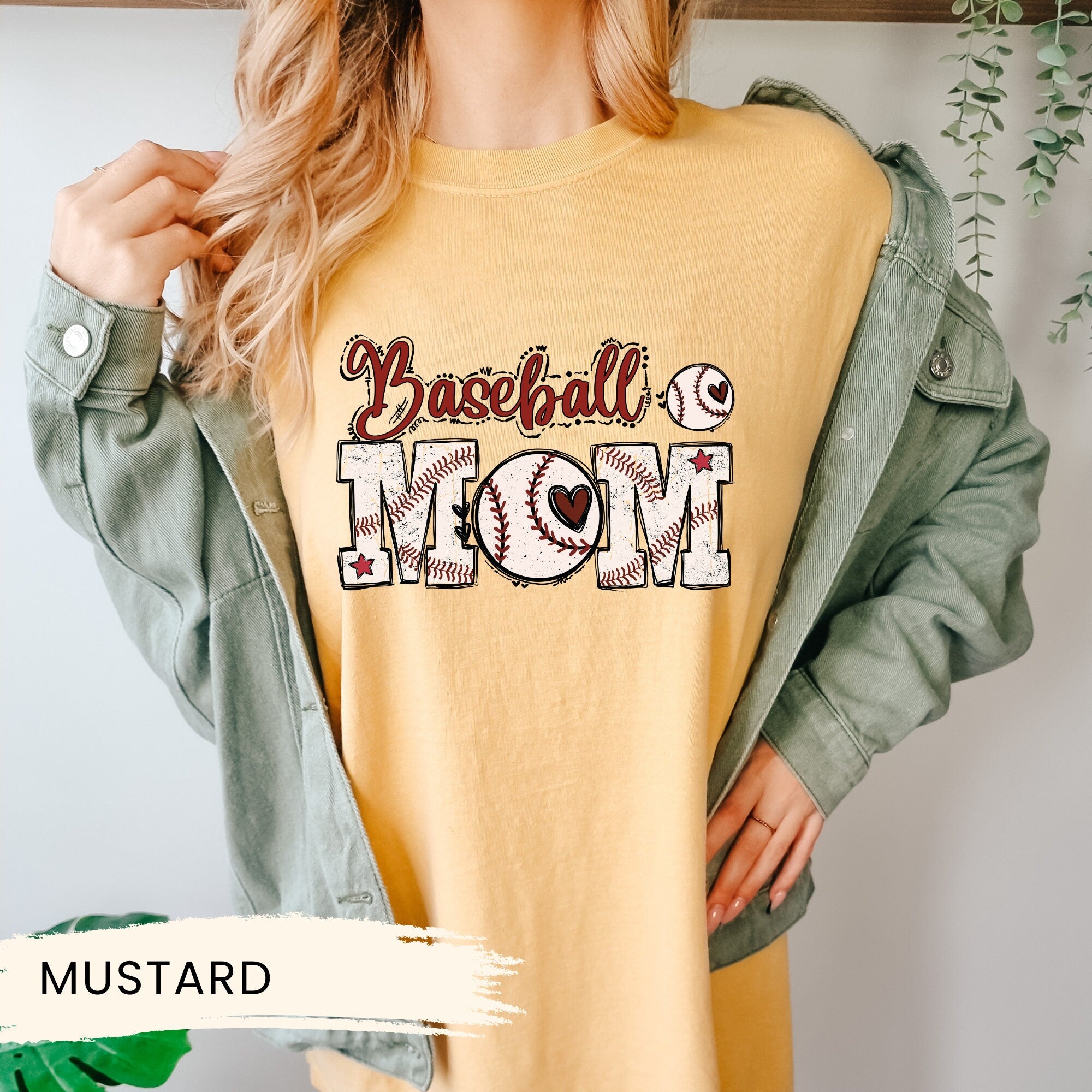 a woman is wearing a baseball mom shirt