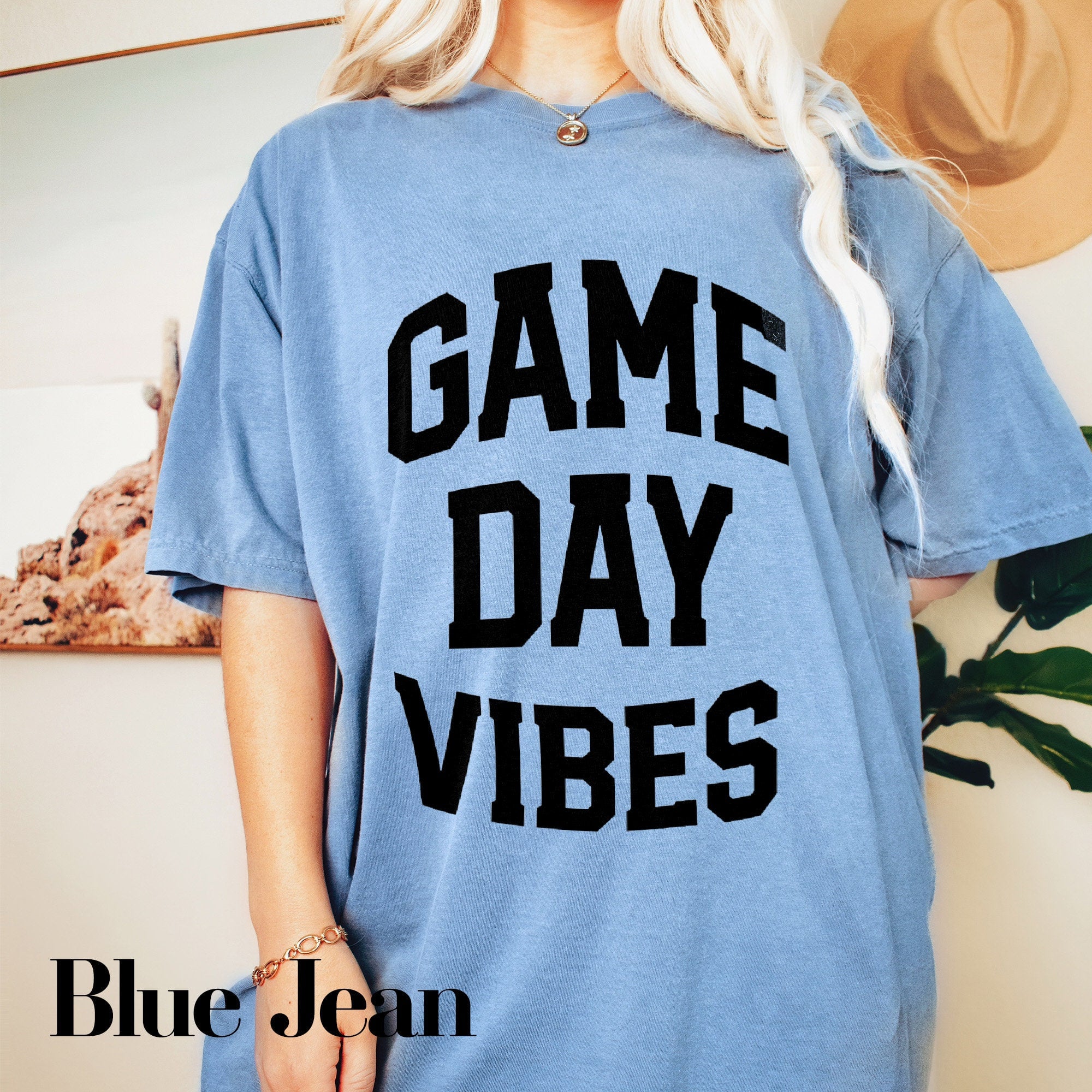 a blonde woman wearing a game day vibes t - shirt