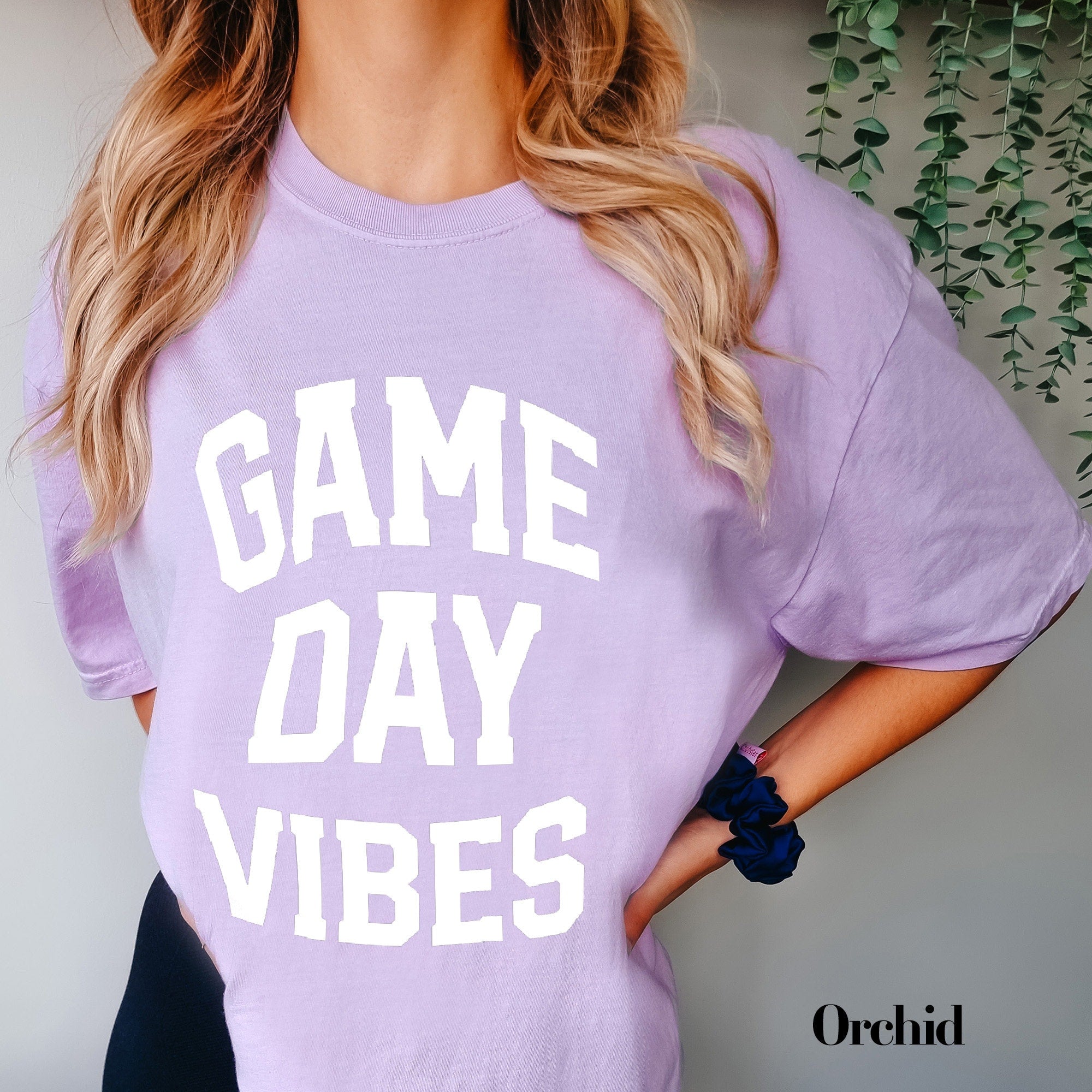 a woman wearing a game day vibes shirt