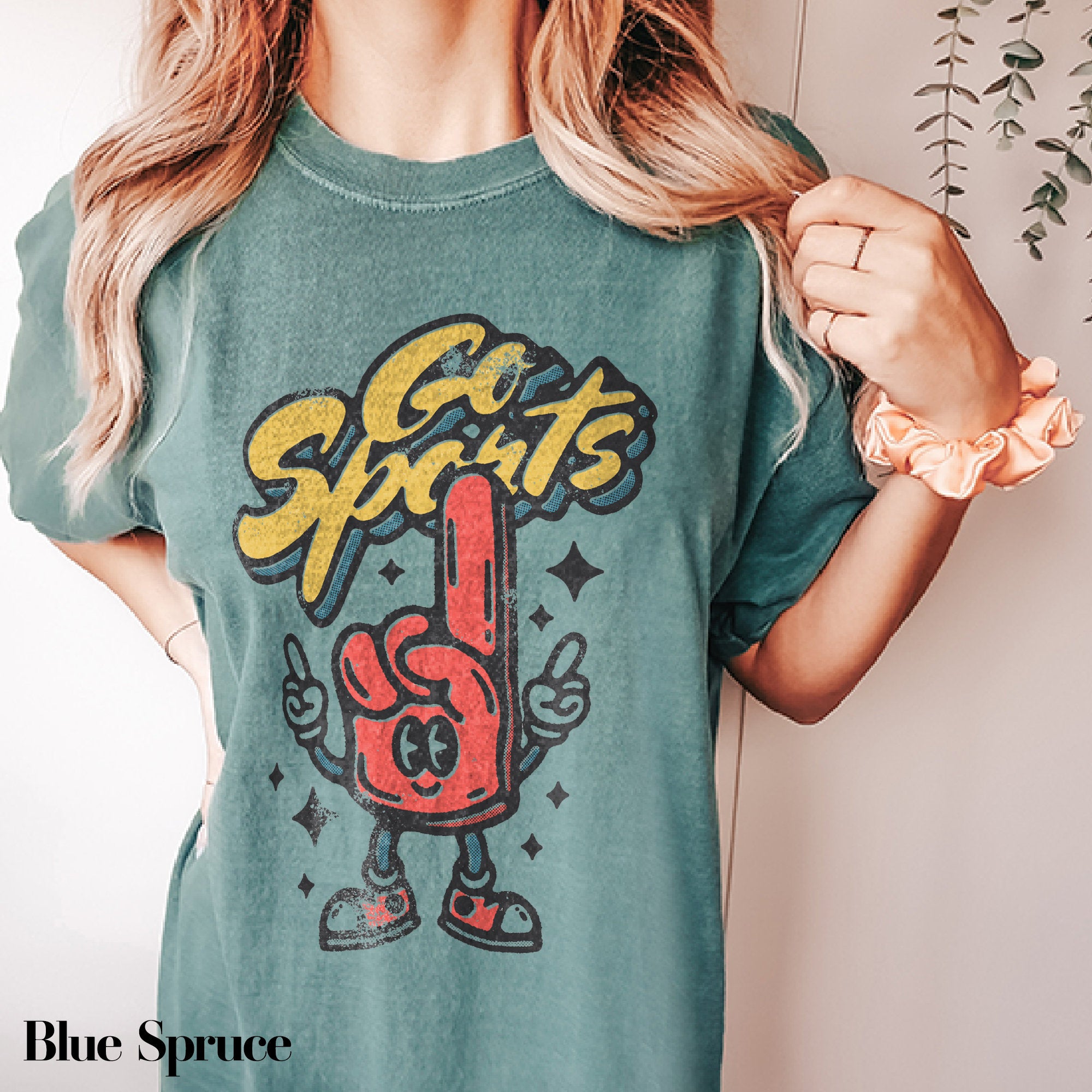 a woman wearing a t - shirt with a cartoon character on it