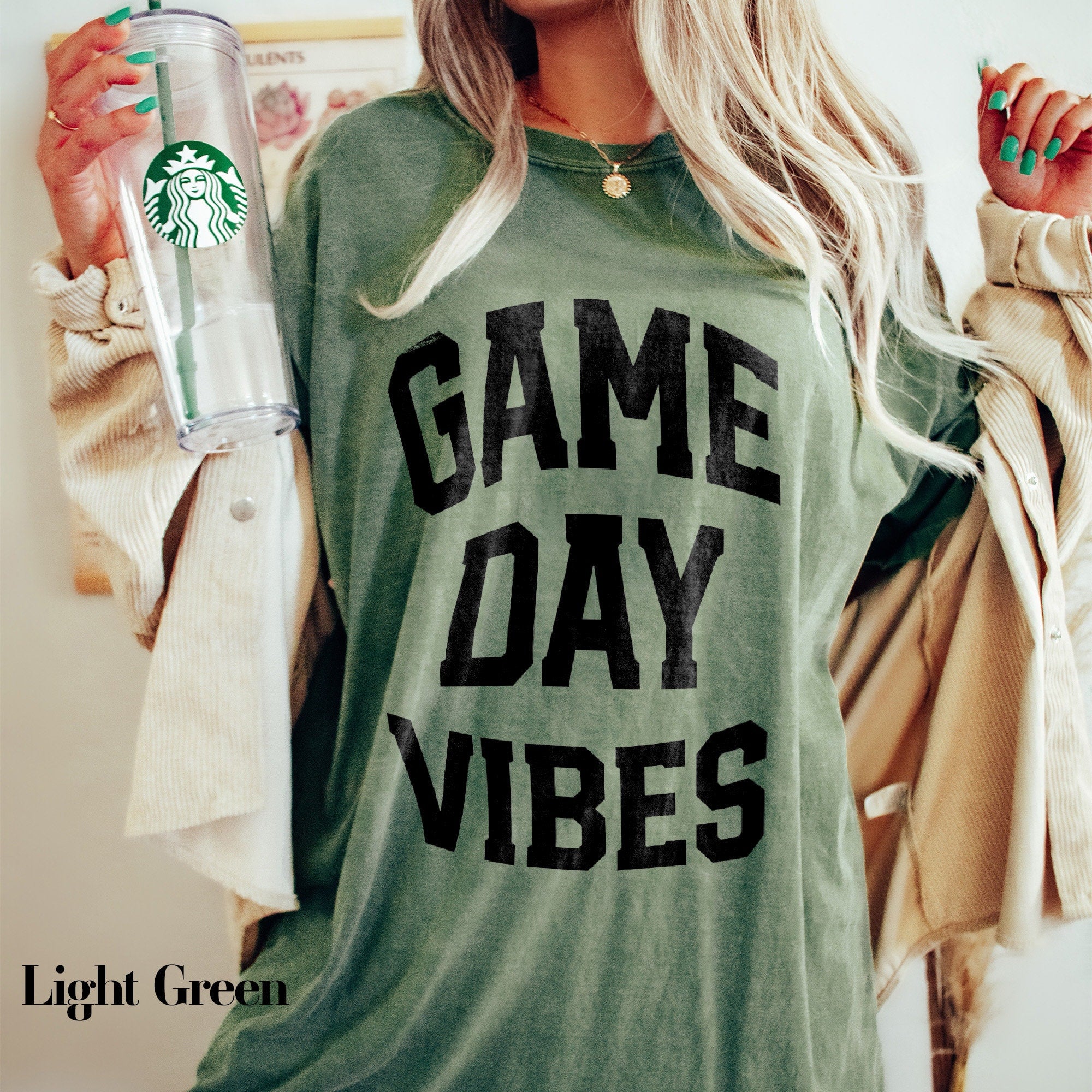 a woman holding a starbucks cup and a water bottle