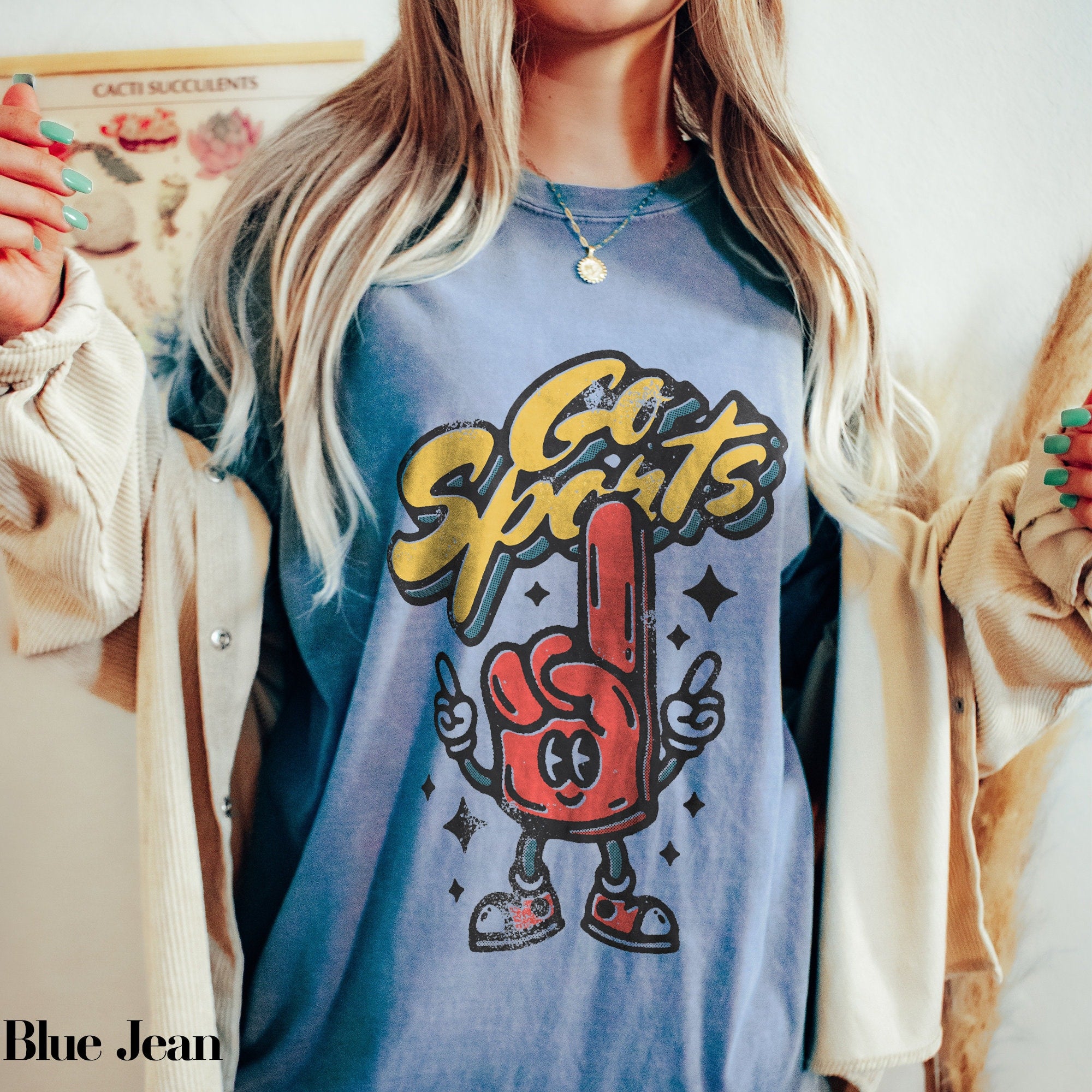 a woman wearing a blue shirt with a red hand on it