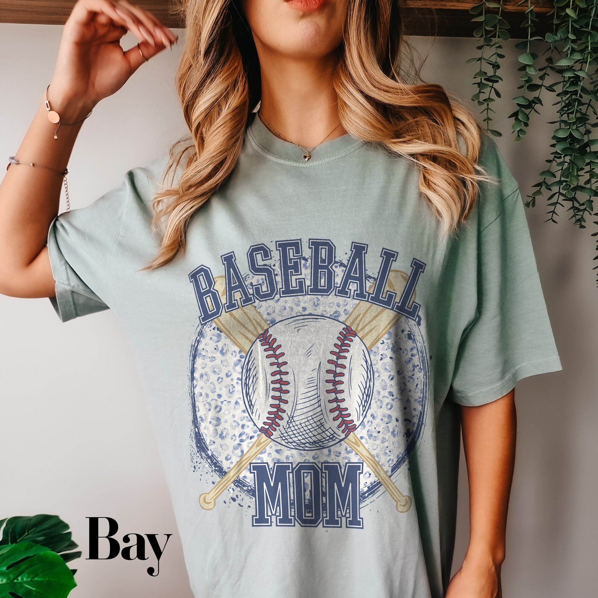 a woman wearing a baseball mom t - shirt