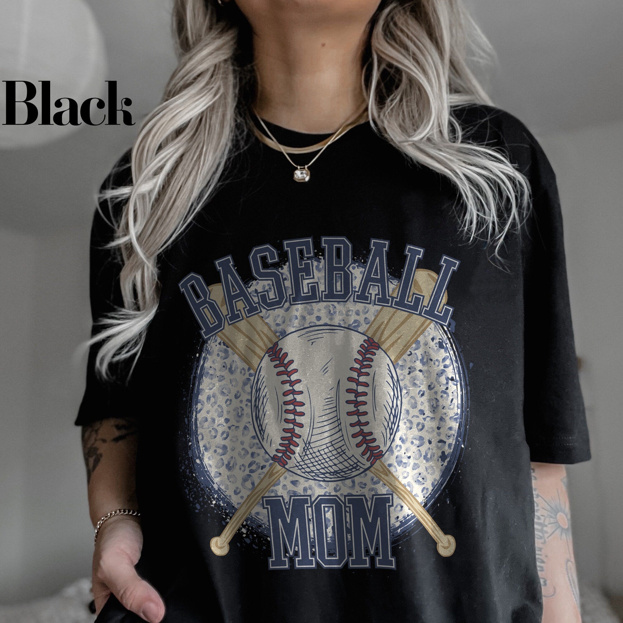 a woman wearing a baseball mom t - shirt