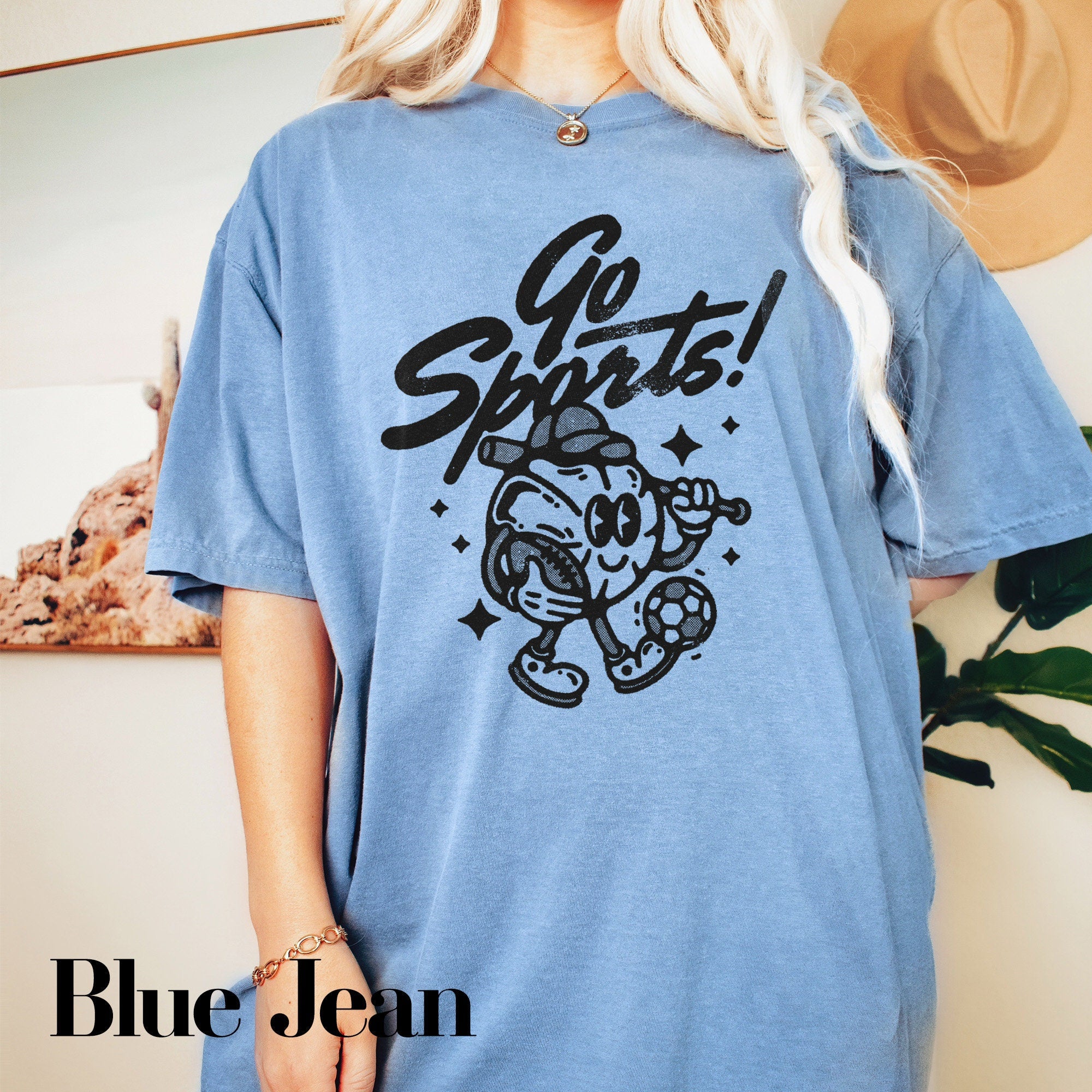 a blonde woman wearing a blue shirt that says go shits