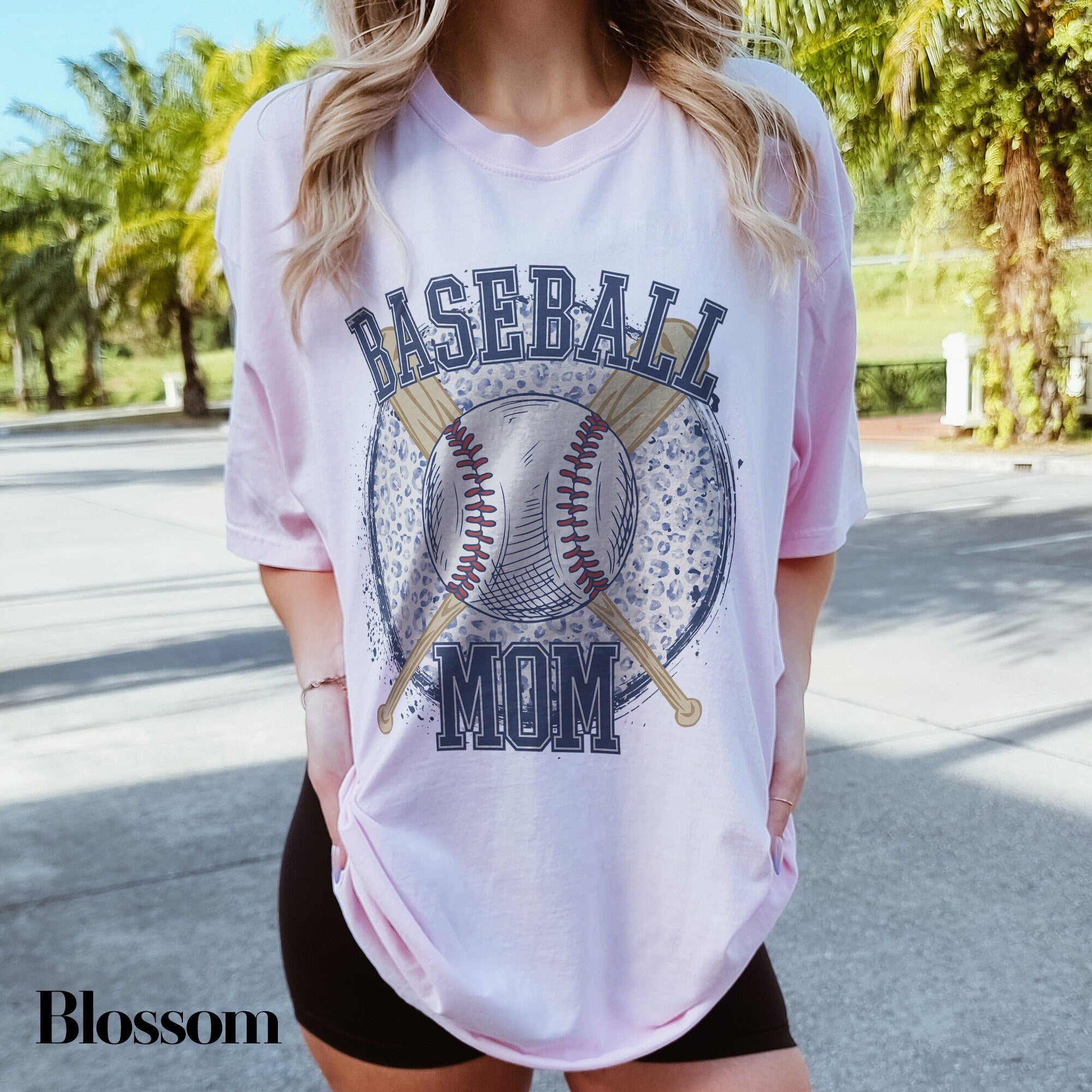 a woman wearing a baseball mom t - shirt