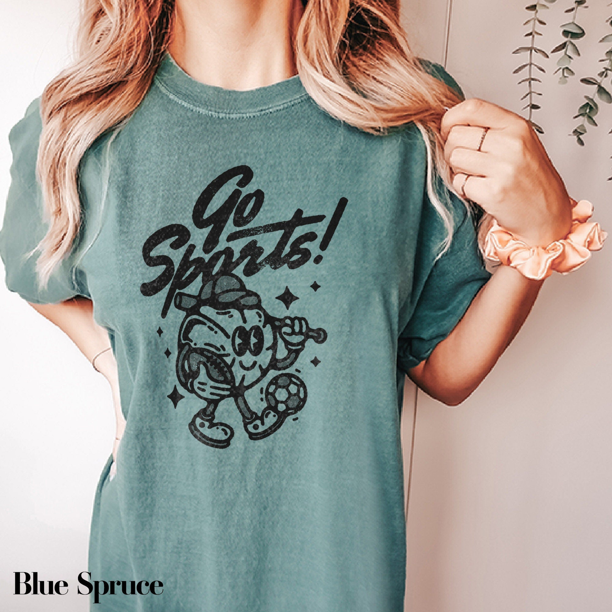 a woman wearing a t - shirt with a cartoon character on it