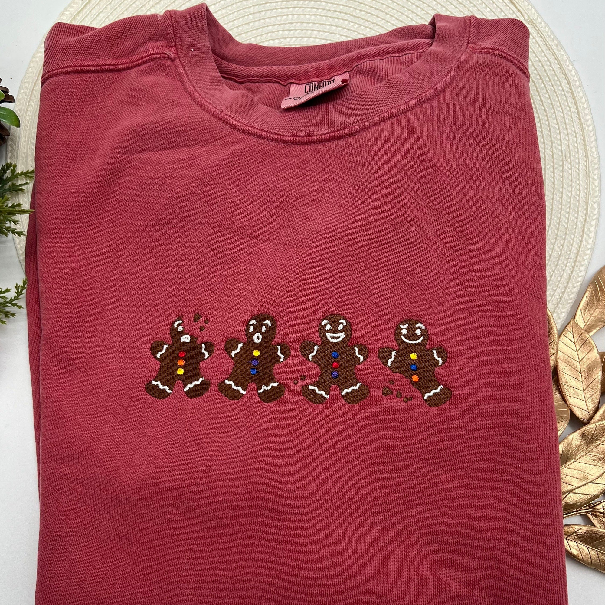 a red t - shirt with three gingerbreads on it