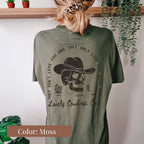 a woman wearing a green shirt with a skull on it