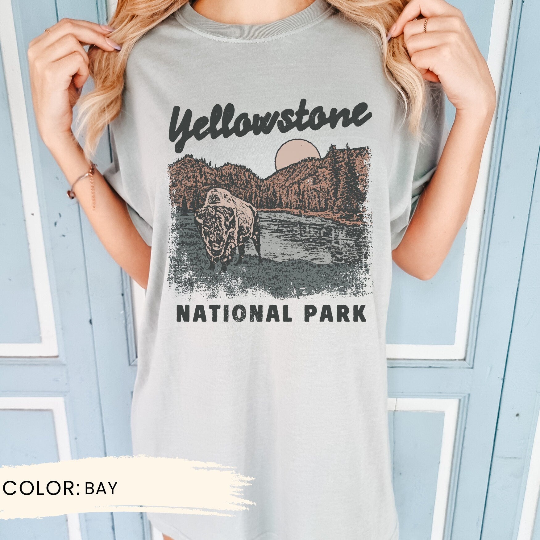 a woman wearing a yellowstone national park t - shirt