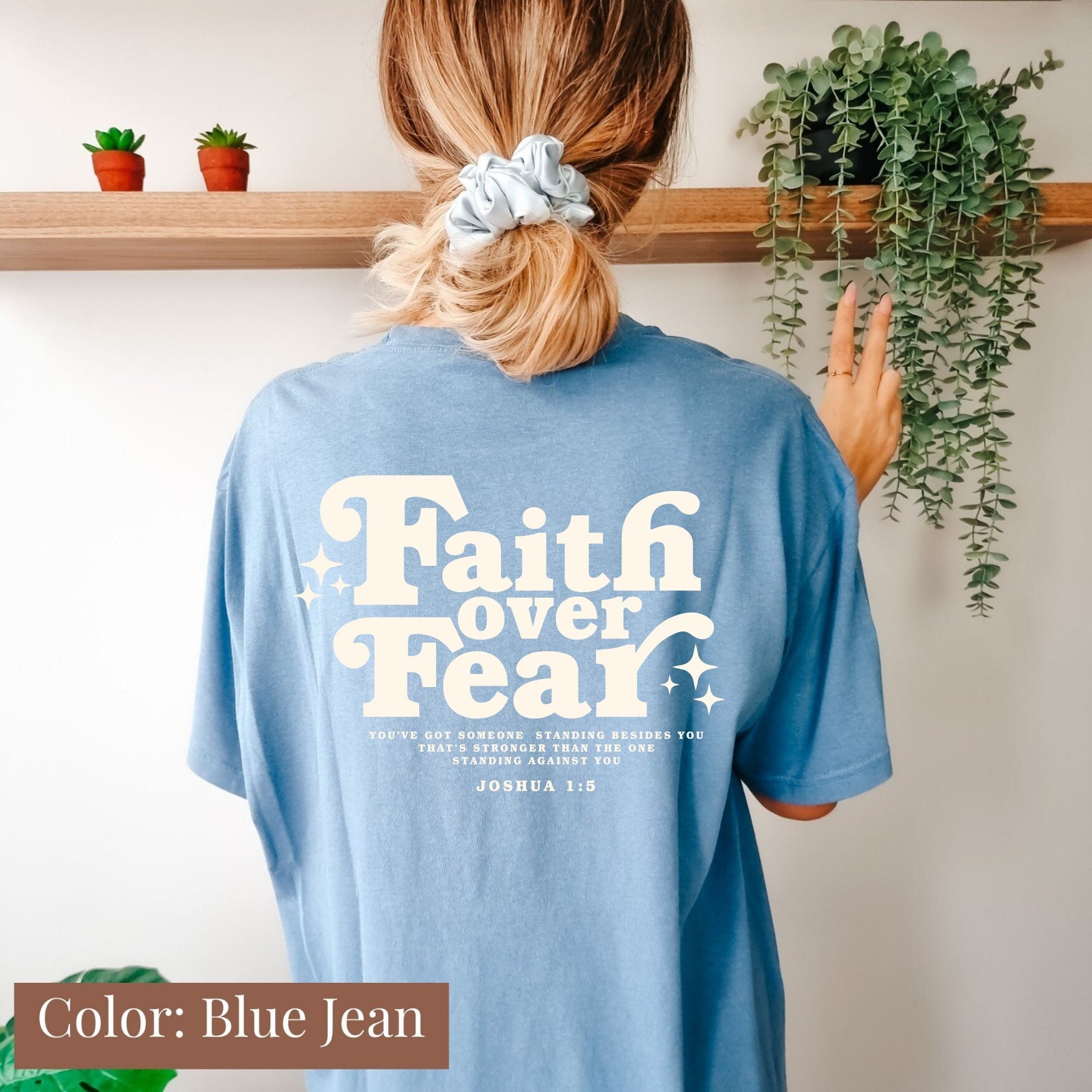 a woman wearing a t - shirt that says faith over fear