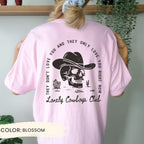 a woman wearing a pink shirt with a skull on it