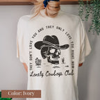 a woman wearing a white shirt with a skull wearing a cowboy hat