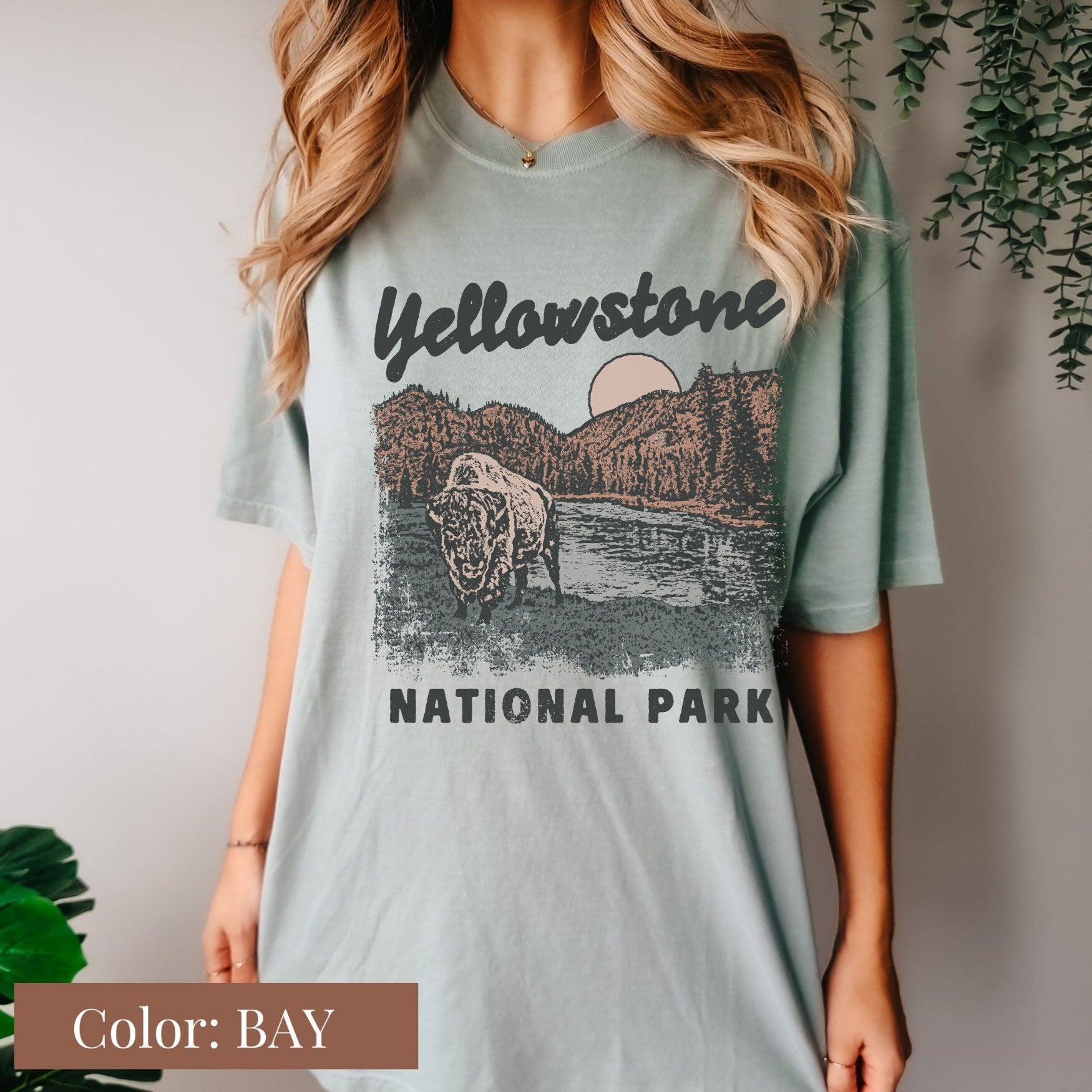 a woman wearing a yellowstone national park t - shirt