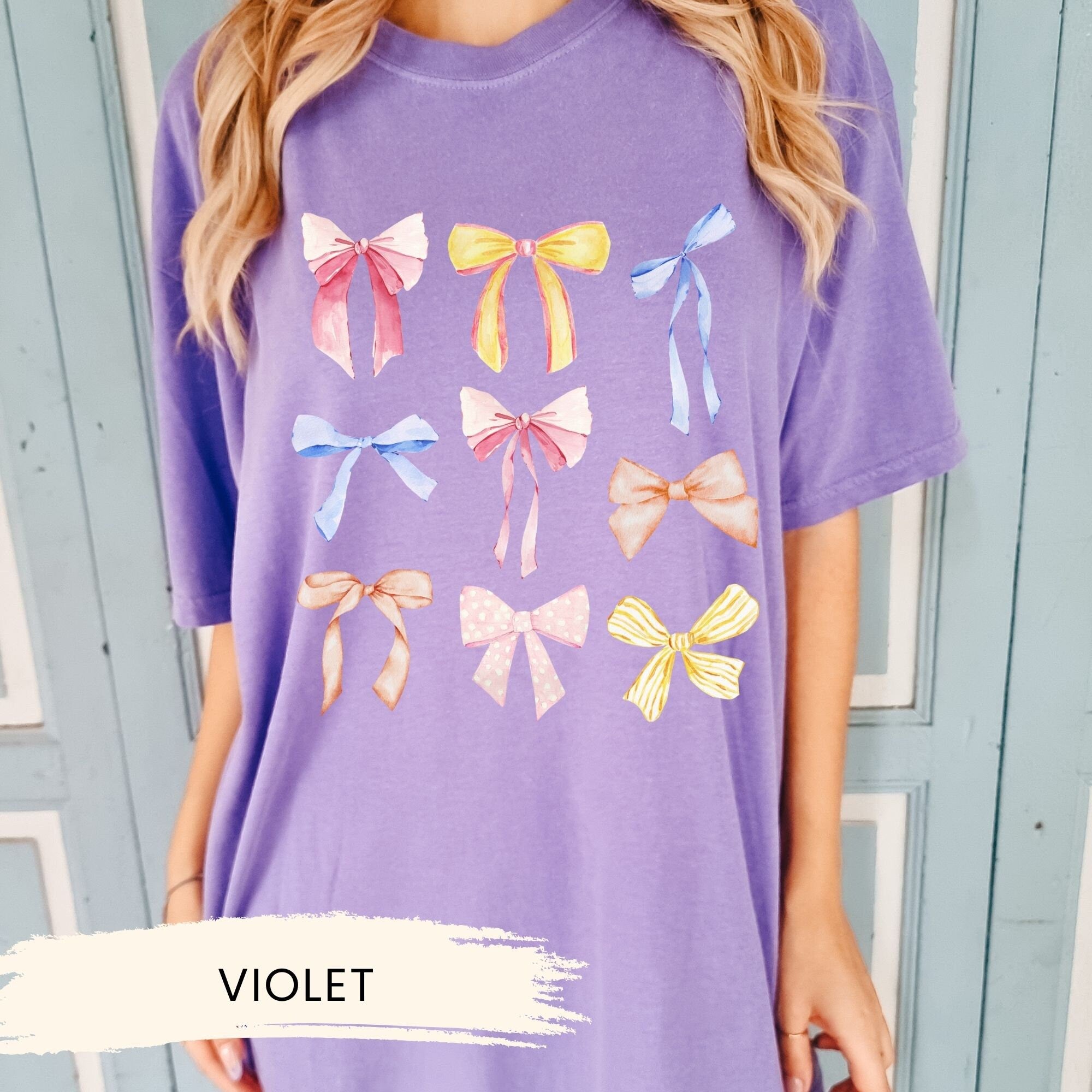 a woman wearing a purple shirt with bows on it