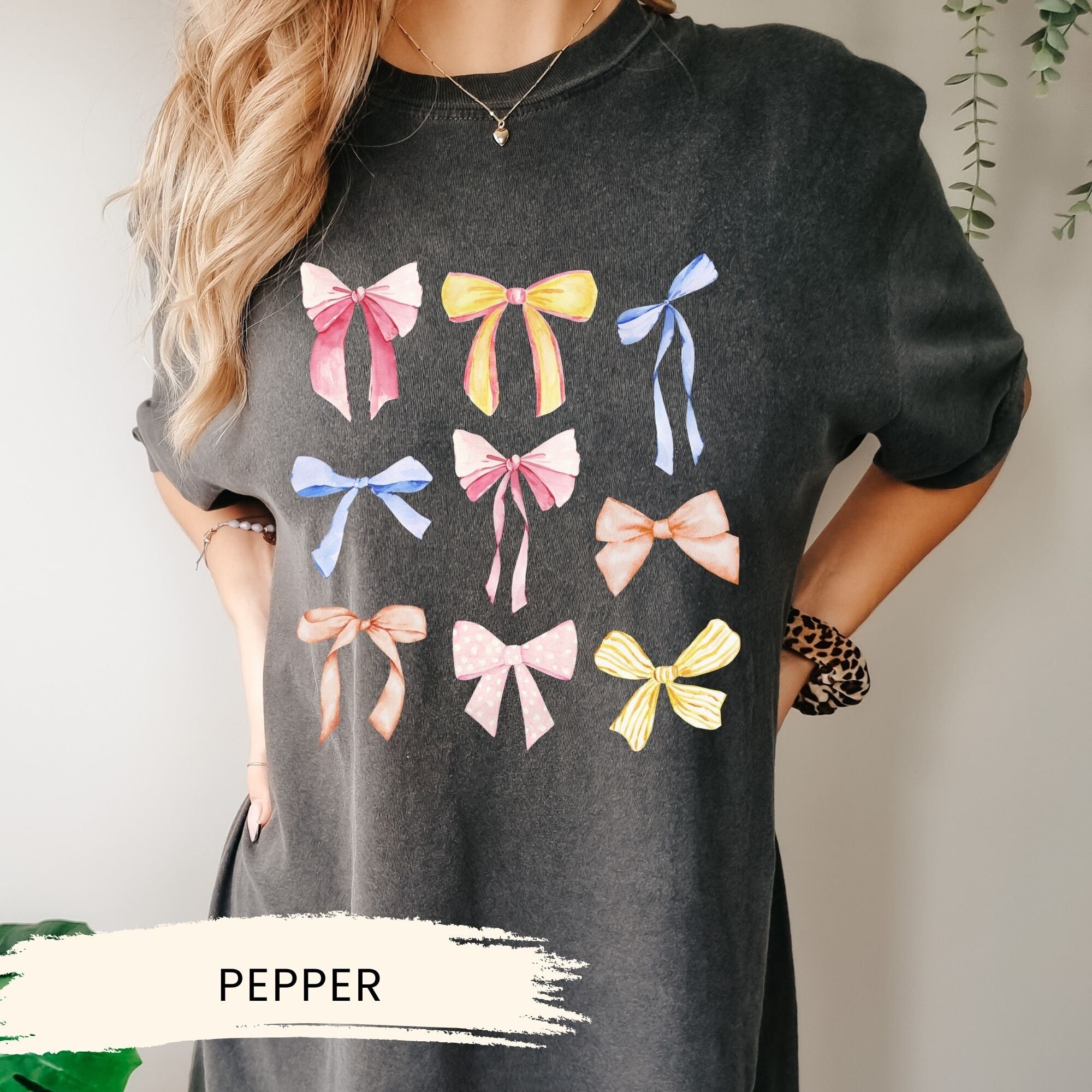 a woman wearing a t - shirt with bows on it