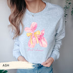 a woman wearing a sweatshirt with a flower on it