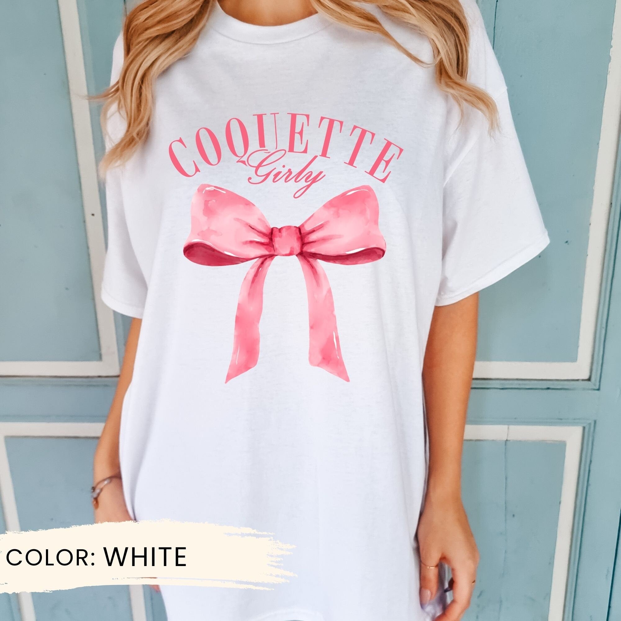 a woman wearing a white shirt with a pink bow
