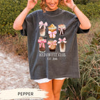 a woman holding up a t - shirt that says iced coffee club