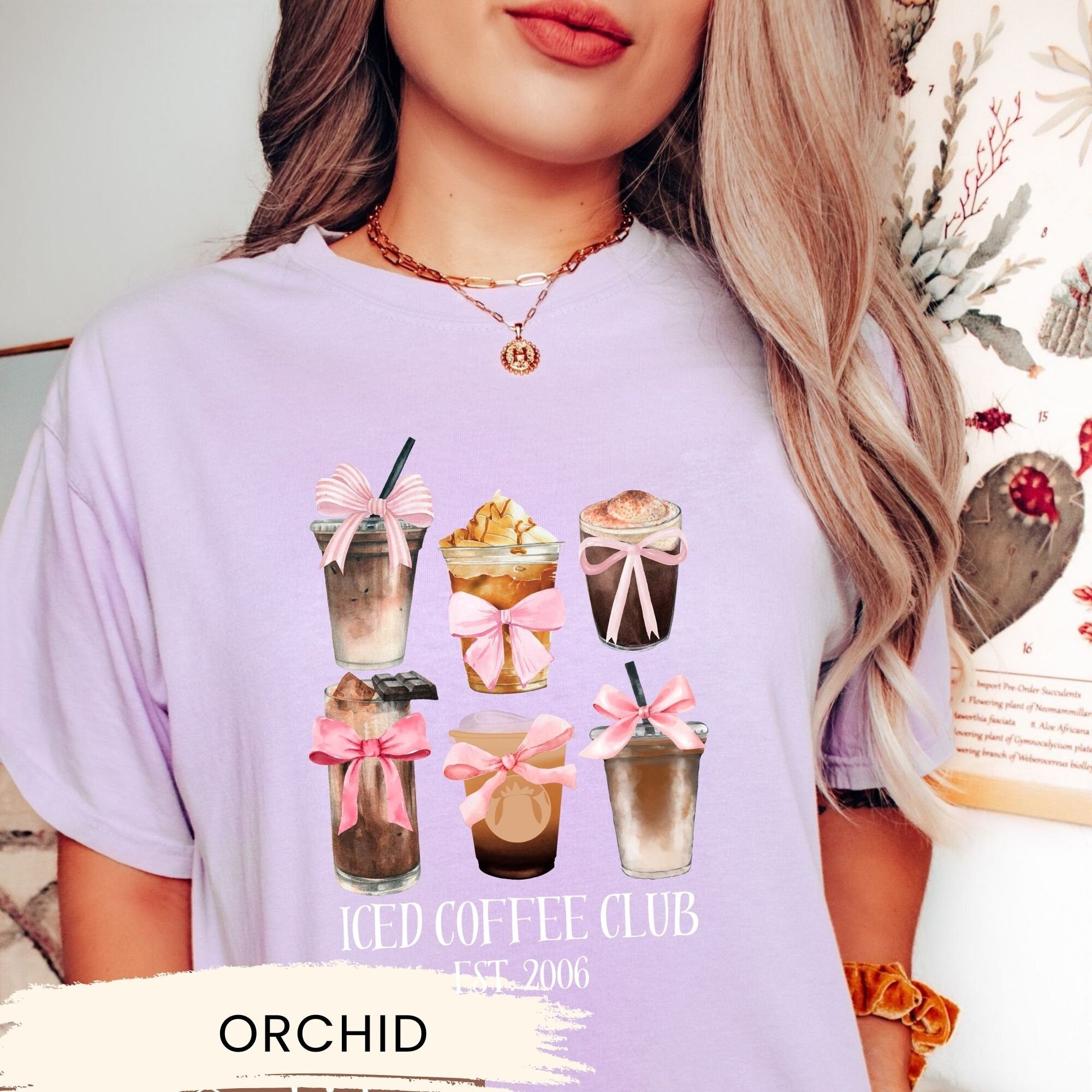 a woman wearing a t - shirt with a picture of a cup of coffee