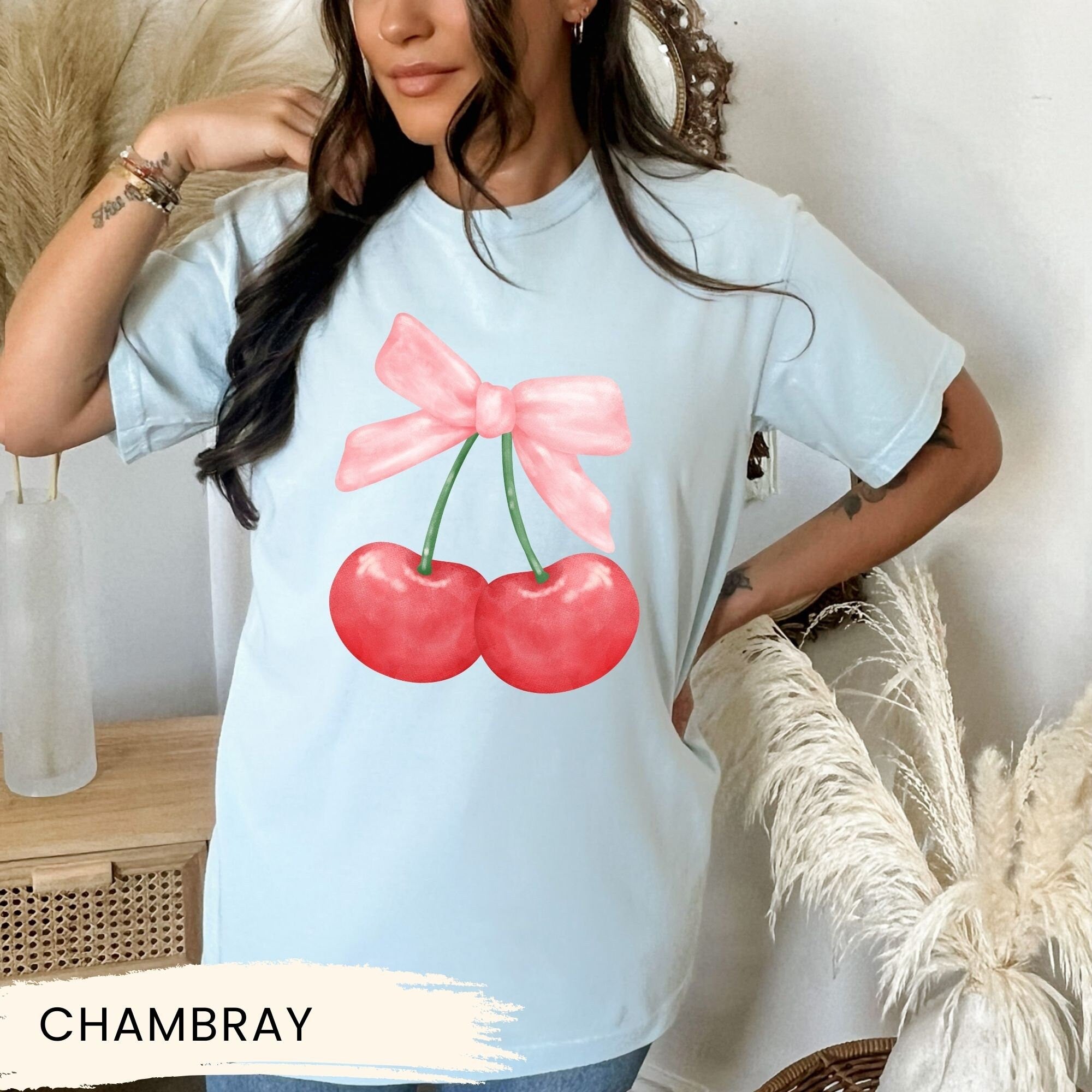 a woman wearing a t - shirt with cherries on it
