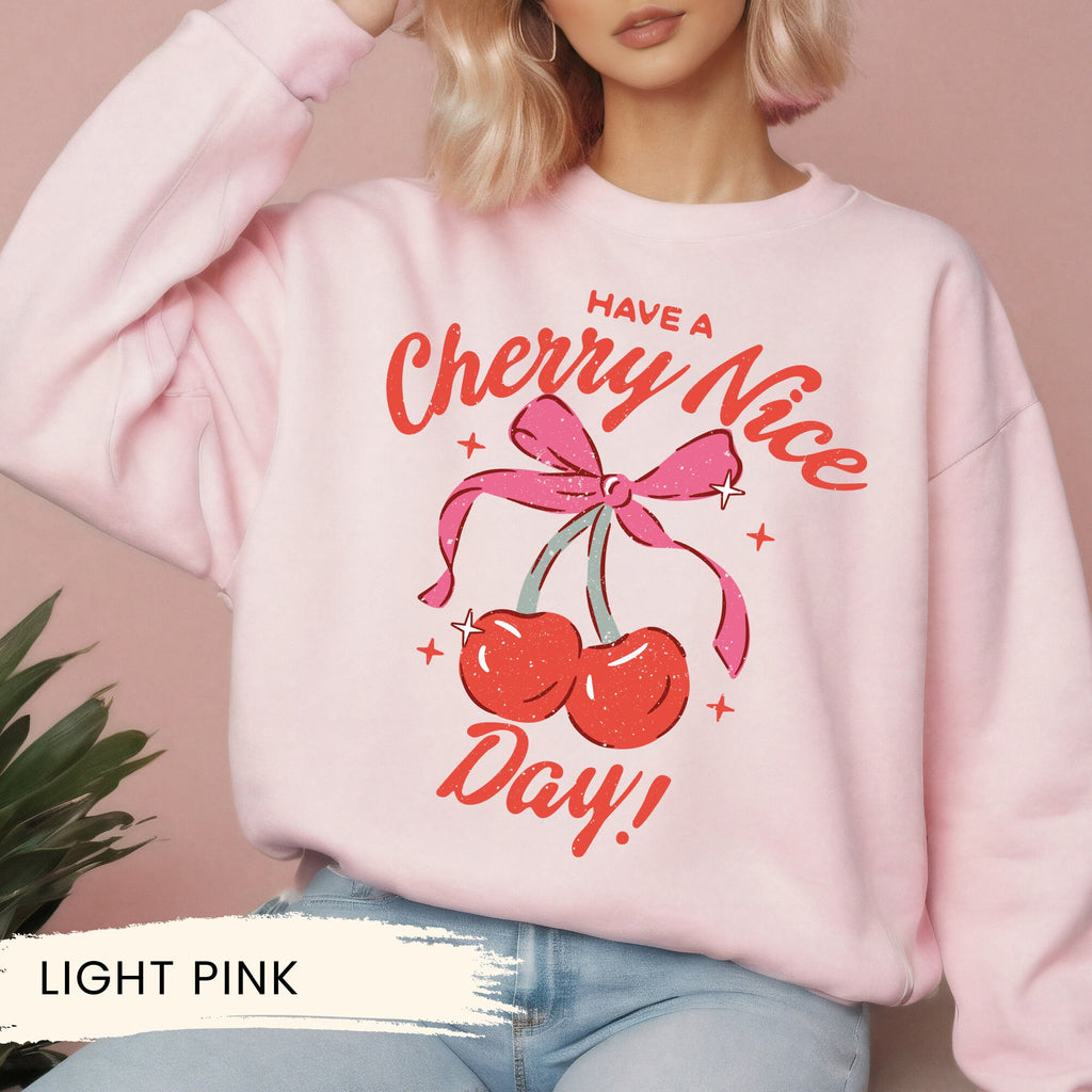 a woman wearing a pink sweatshirt that says have a cherry nice day