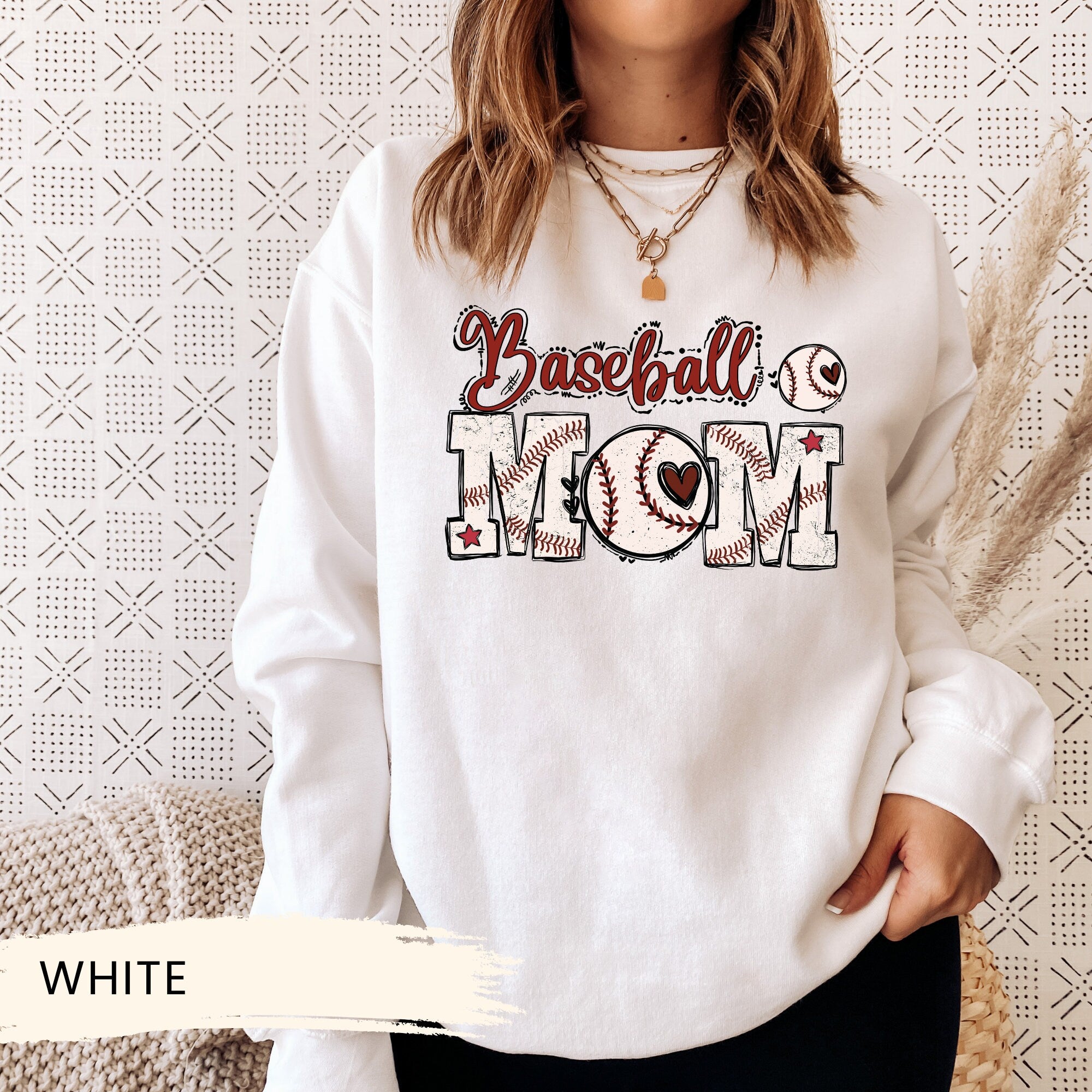 a woman wearing a baseball mom sweatshirt