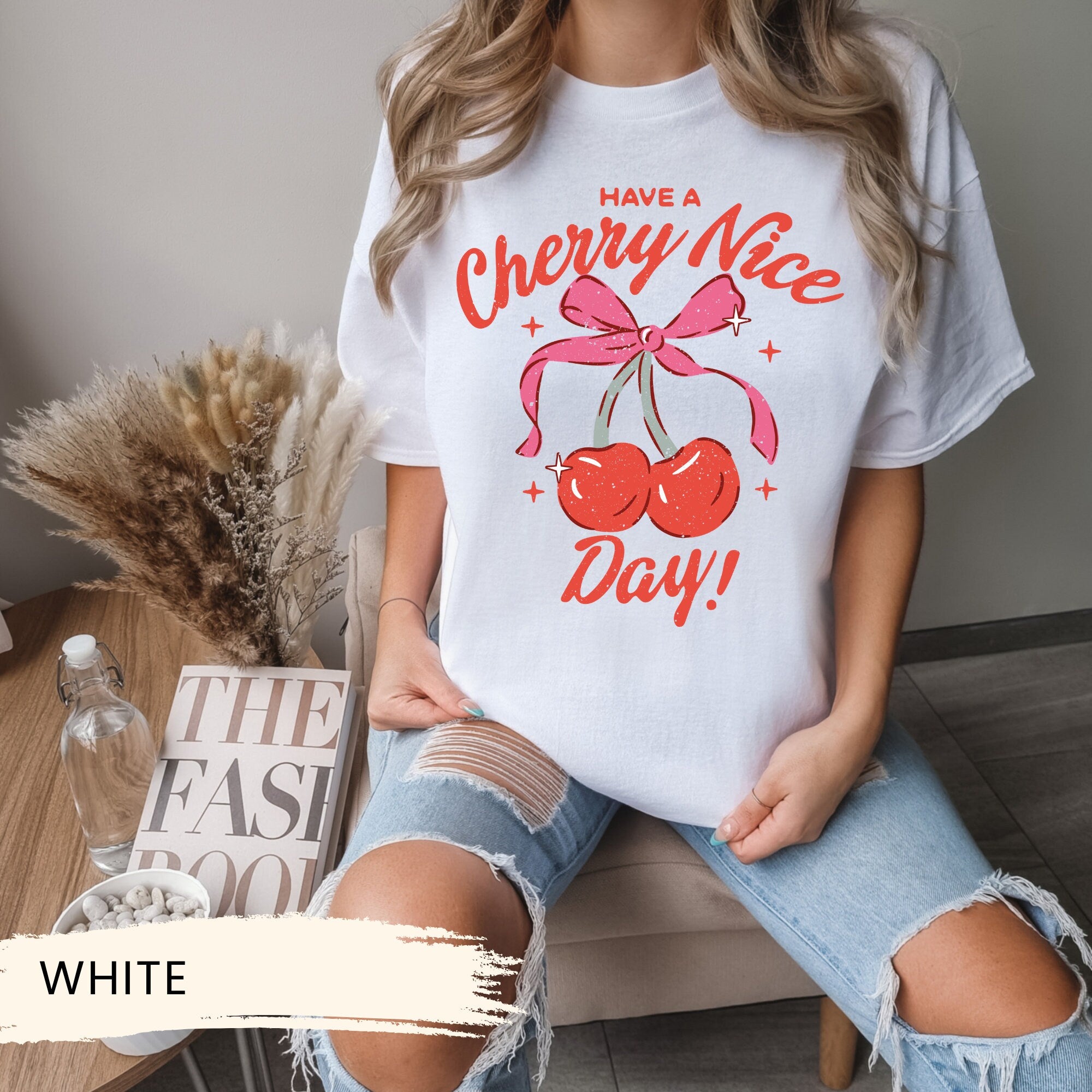 a woman wearing a cherry nice day t - shirt