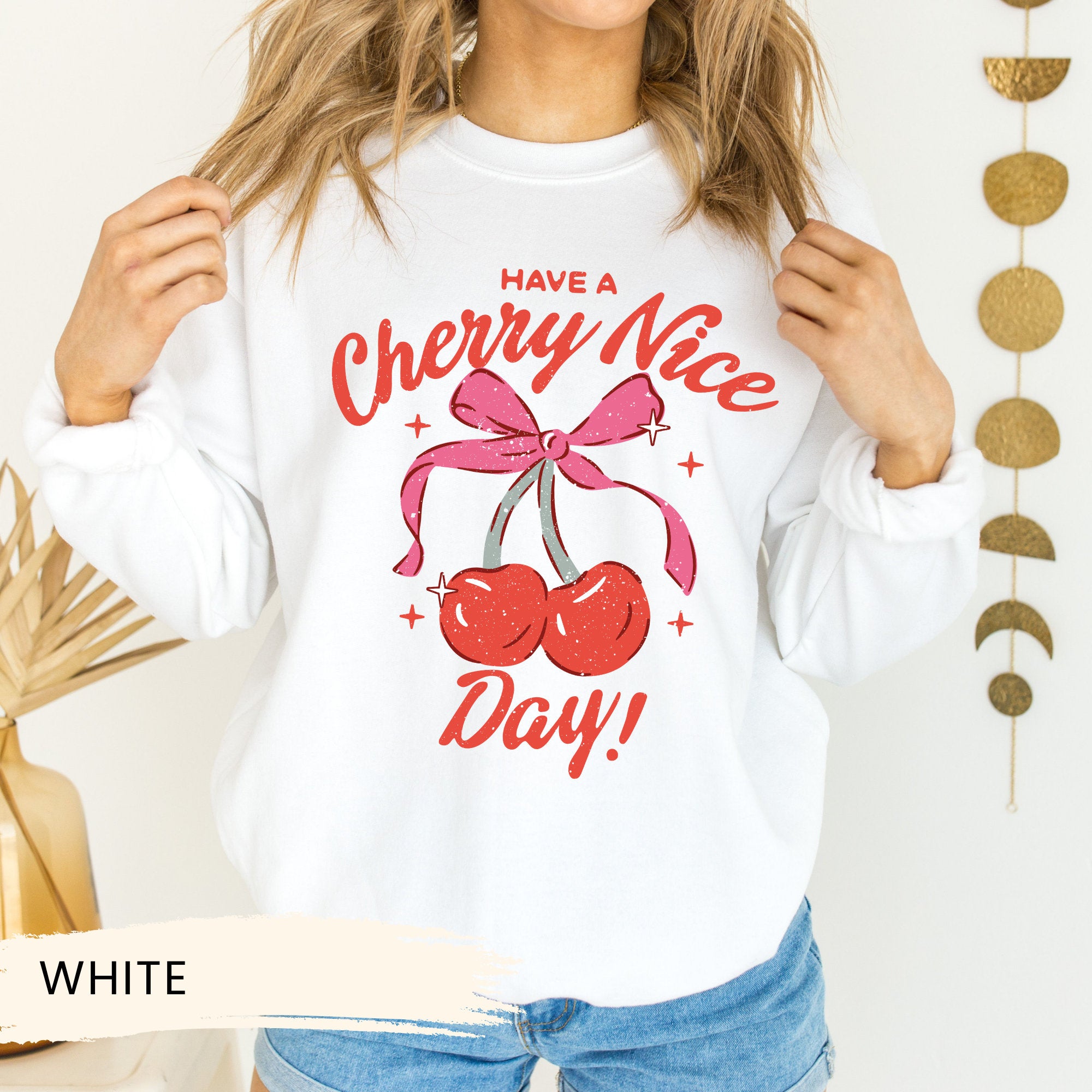 a woman wearing a cherry nice day sweatshirt