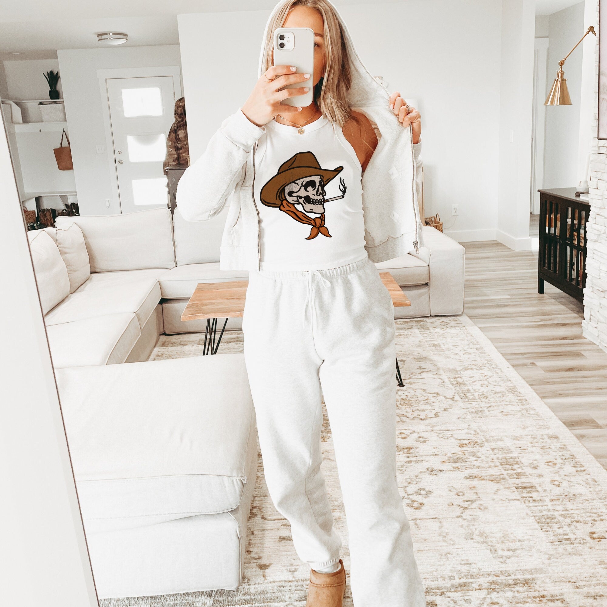 a woman taking a selfie in a living room