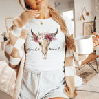 a woman holding a cup of coffee and wearing a sweater