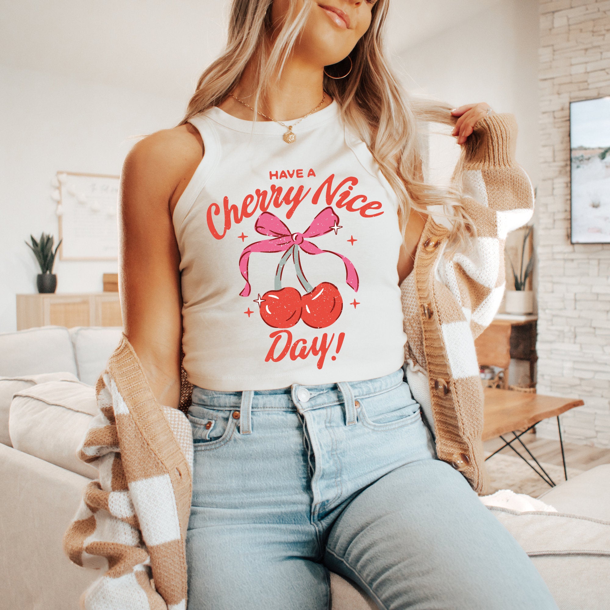a woman sitting on a couch wearing a tank top