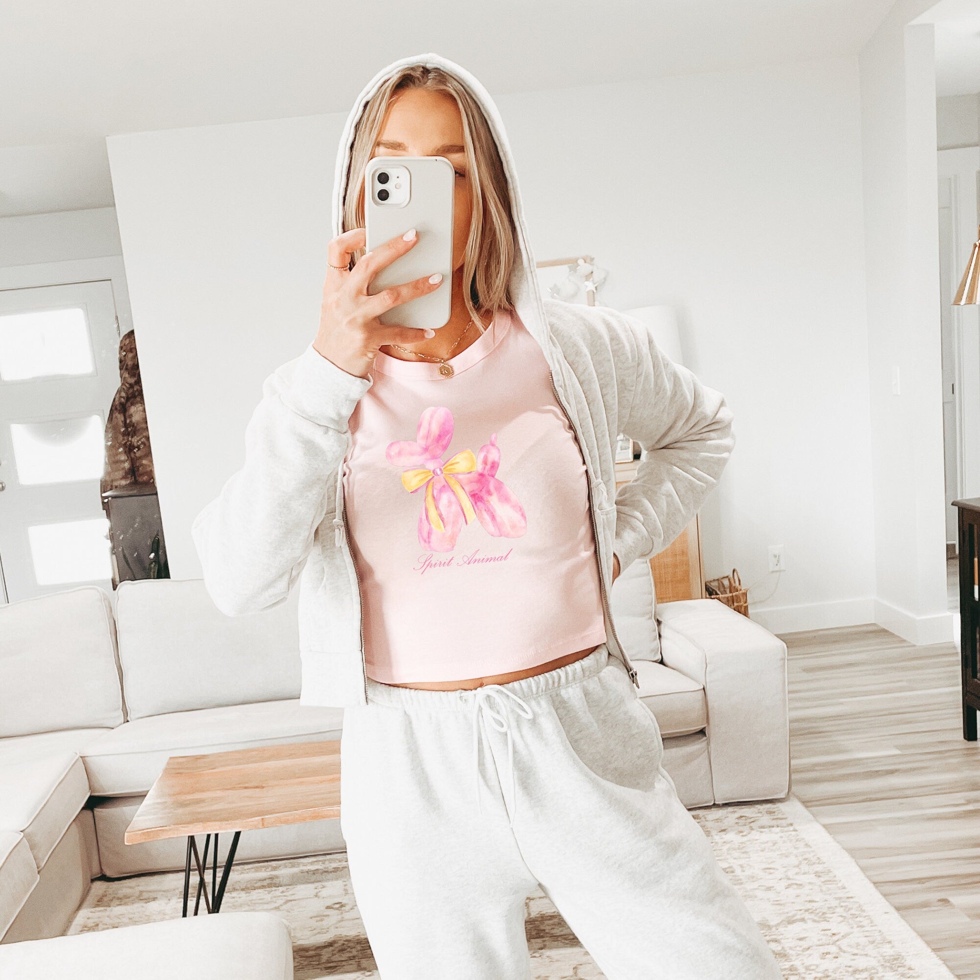 a woman taking a selfie in a living room