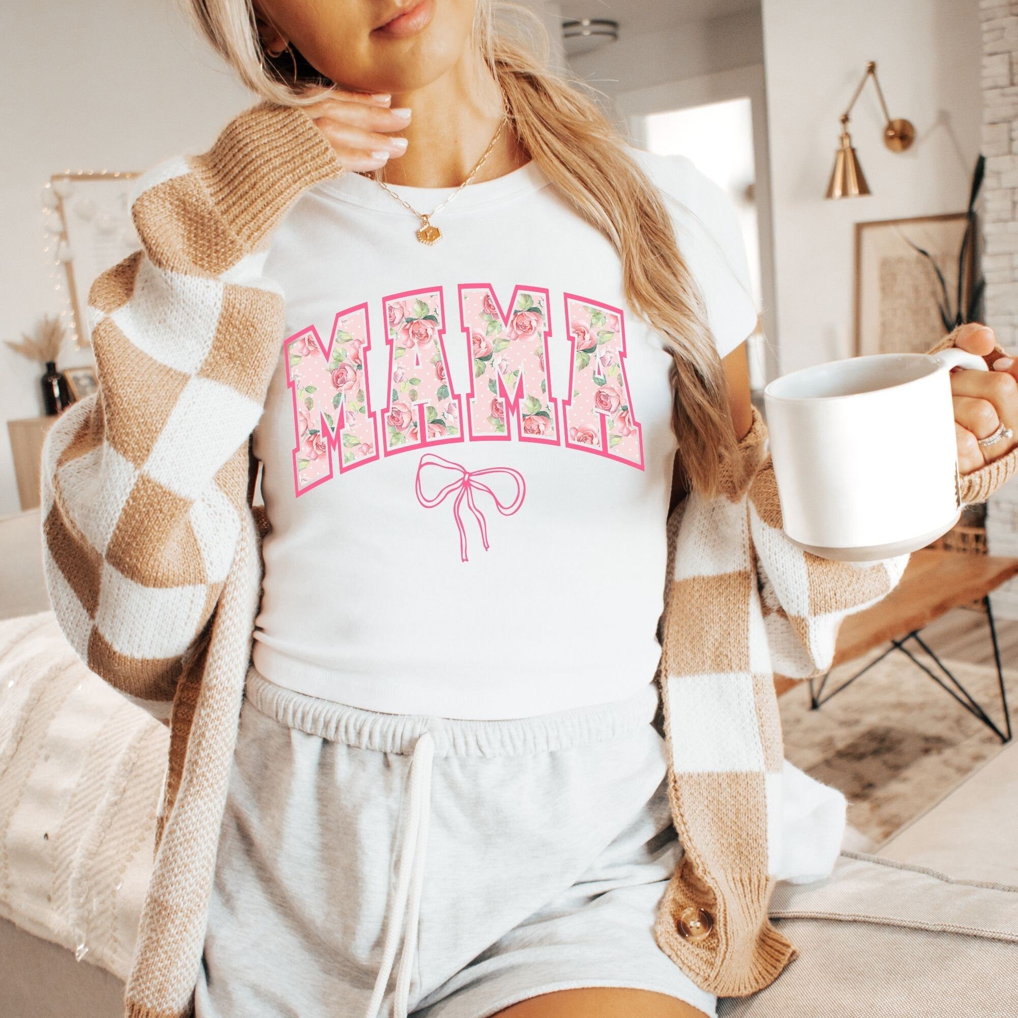 a woman holding a cup of coffee and a sweater