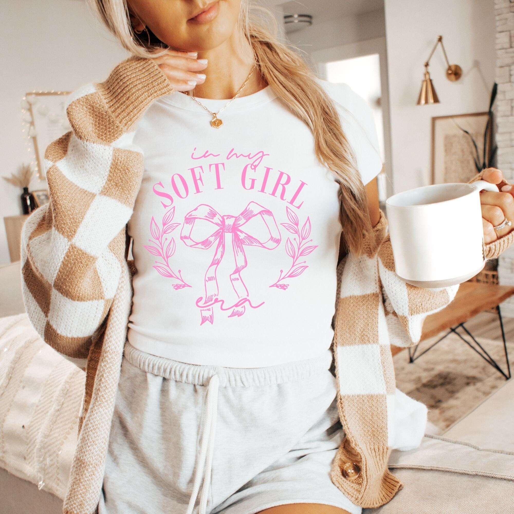 a woman holding a cup of coffee in her hand