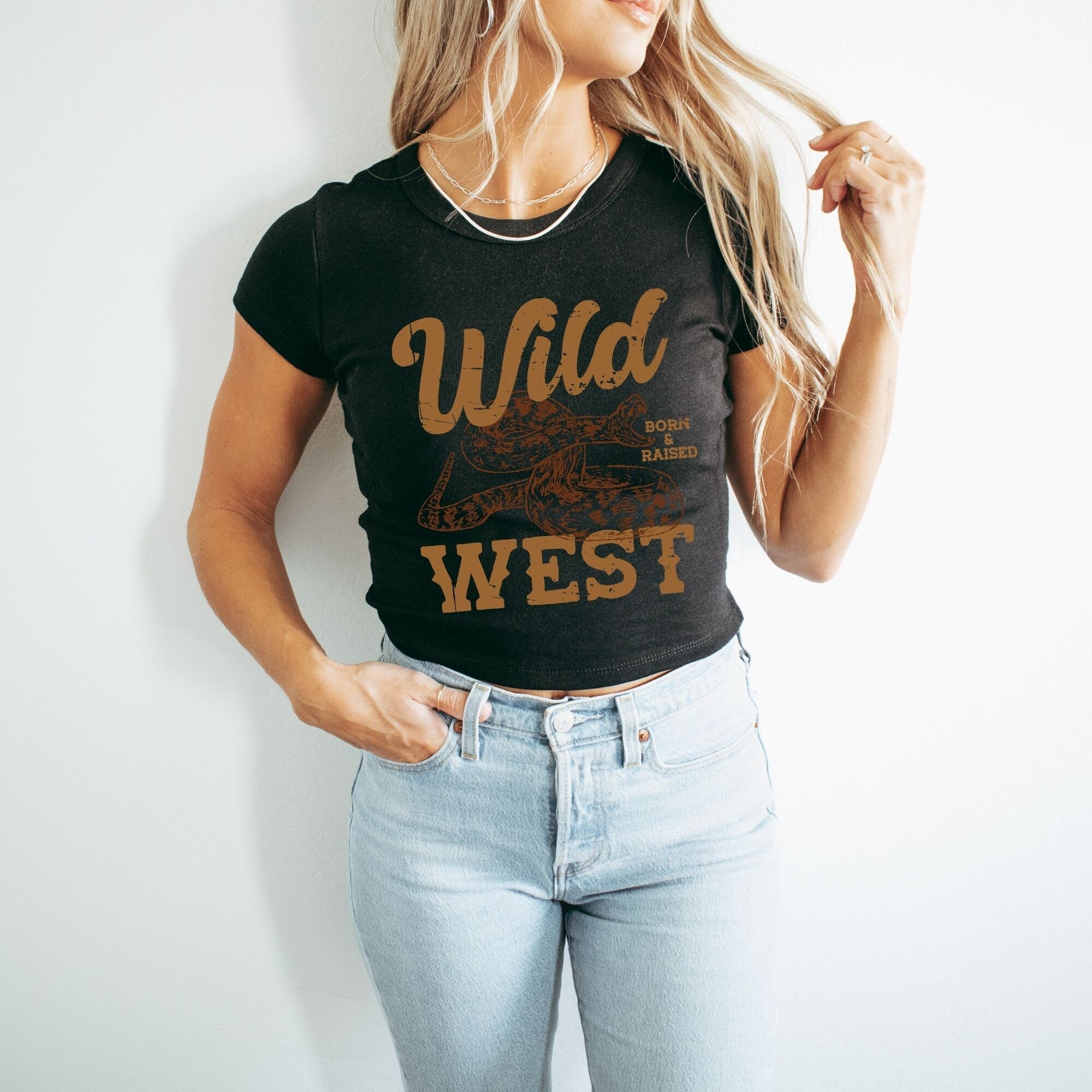 a woman wearing a wild west t - shirt