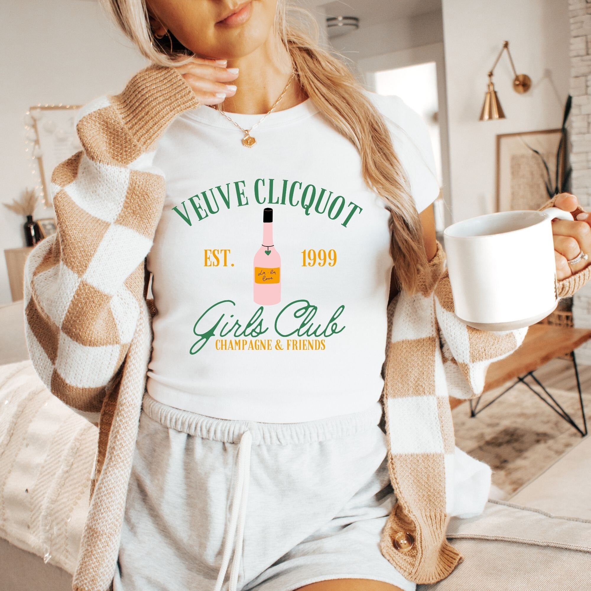 a woman is holding a cup of coffee
