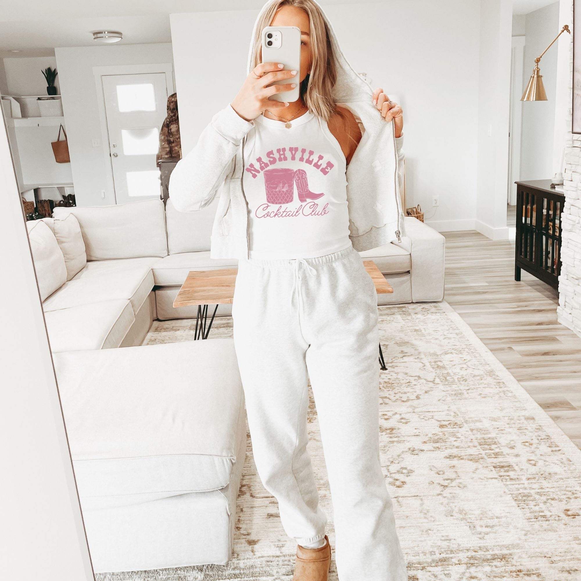 a woman taking a selfie in a living room