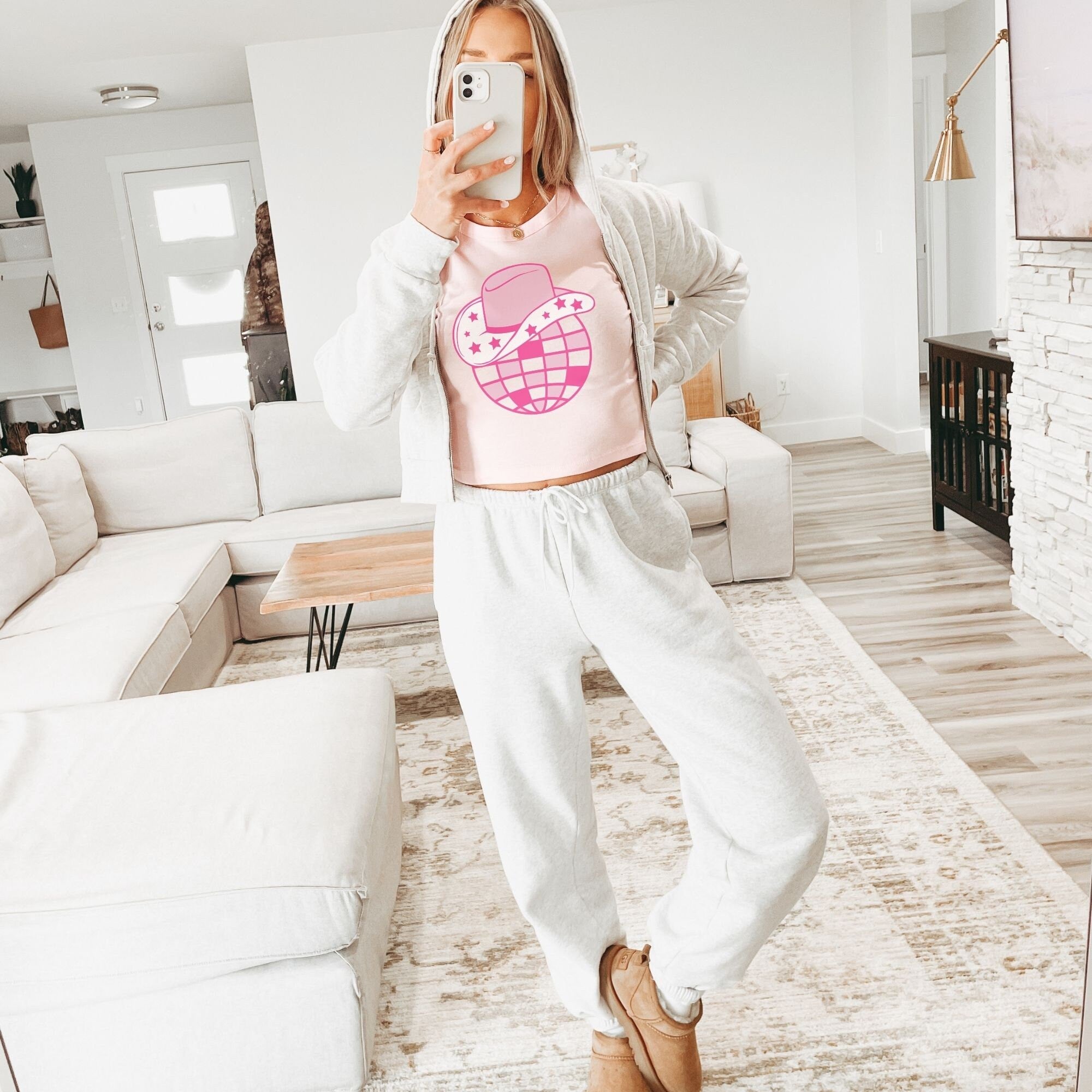 a woman taking a selfie in a living room