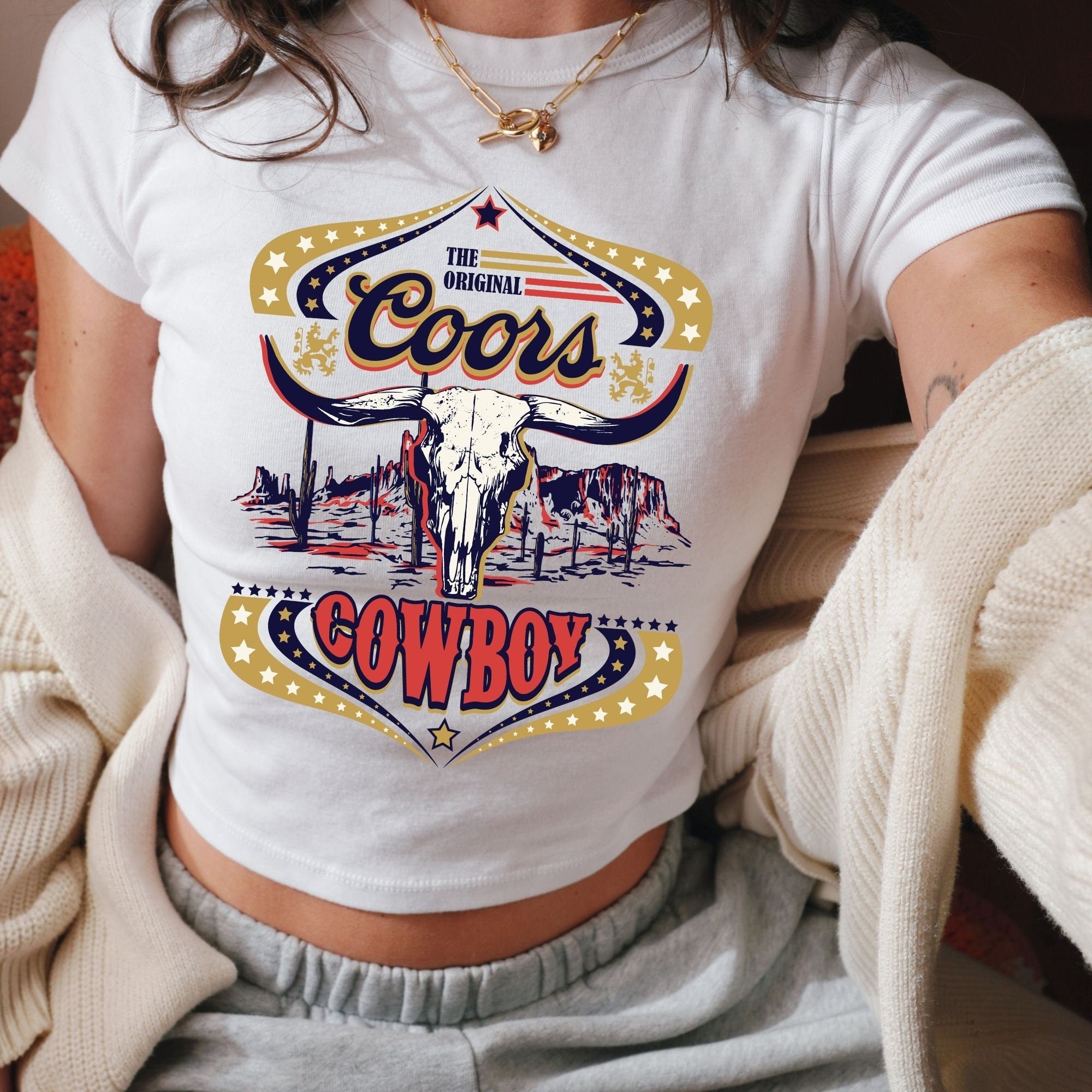 a woman wearing a white shirt with a cow on it