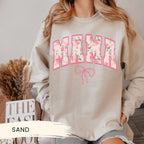 a woman wearing a sweatshirt with the word mama printed on it