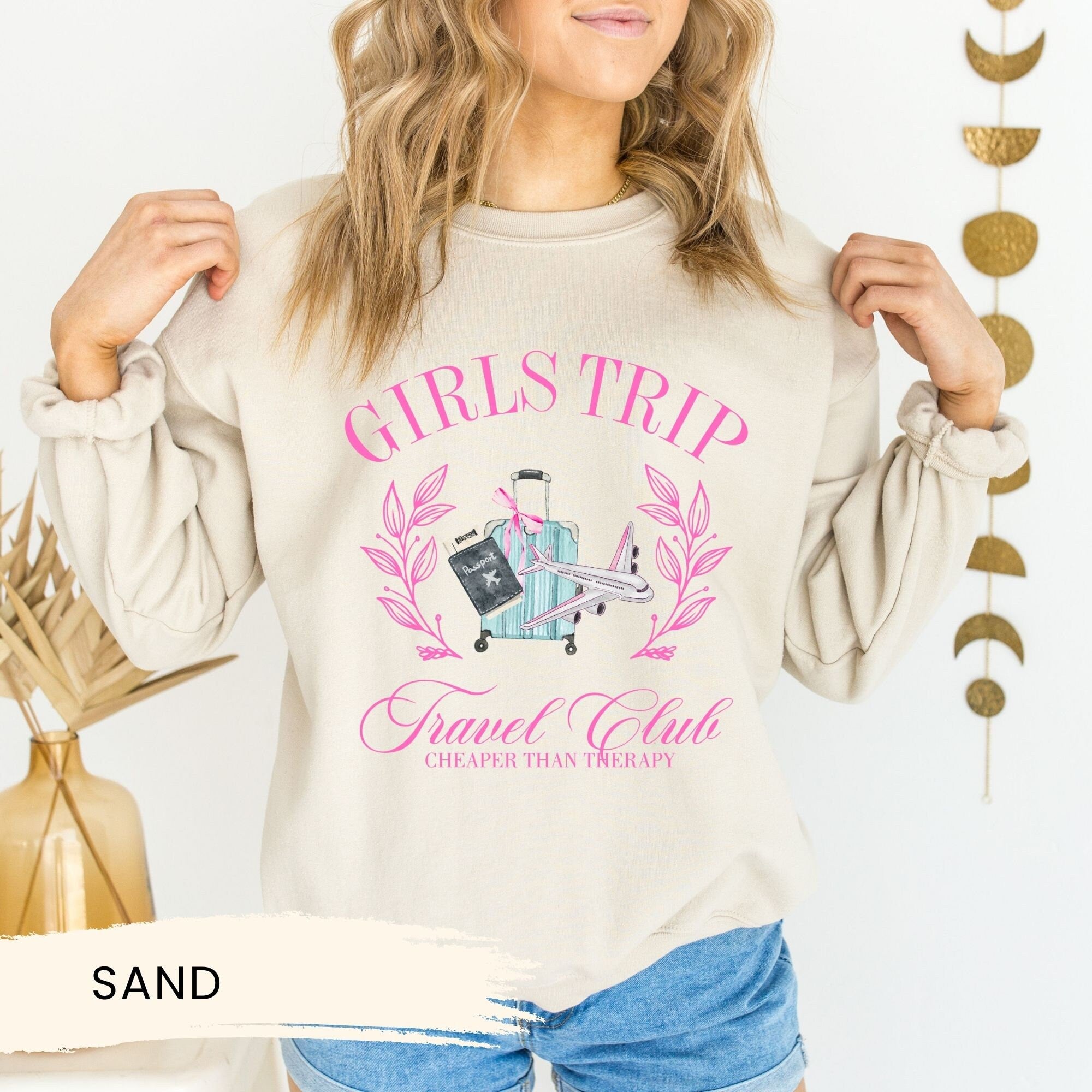 a woman wearing a sweatshirt that says girls trip
