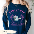 a woman wearing a blue shirt with a picture of a girl&#39;s trip on