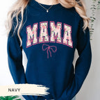 a woman wearing a sweatshirt with the word mama on it
