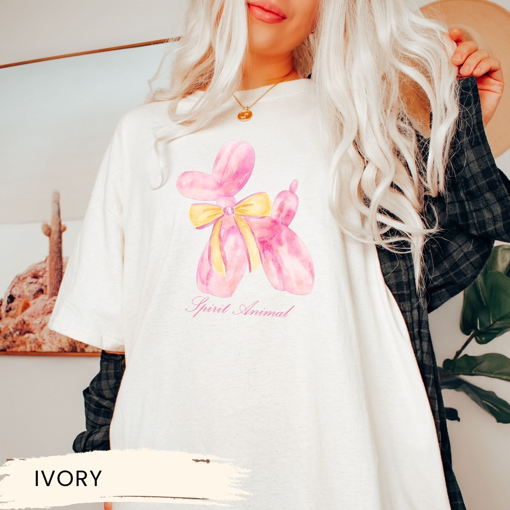 a woman wearing a white shirt with a pink bow on it