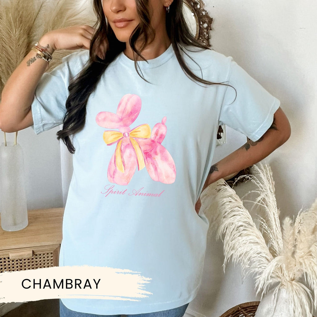 a woman wearing a blue shirt with a pink flower on it