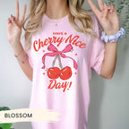 a woman wearing a pink cherry nice day shirt