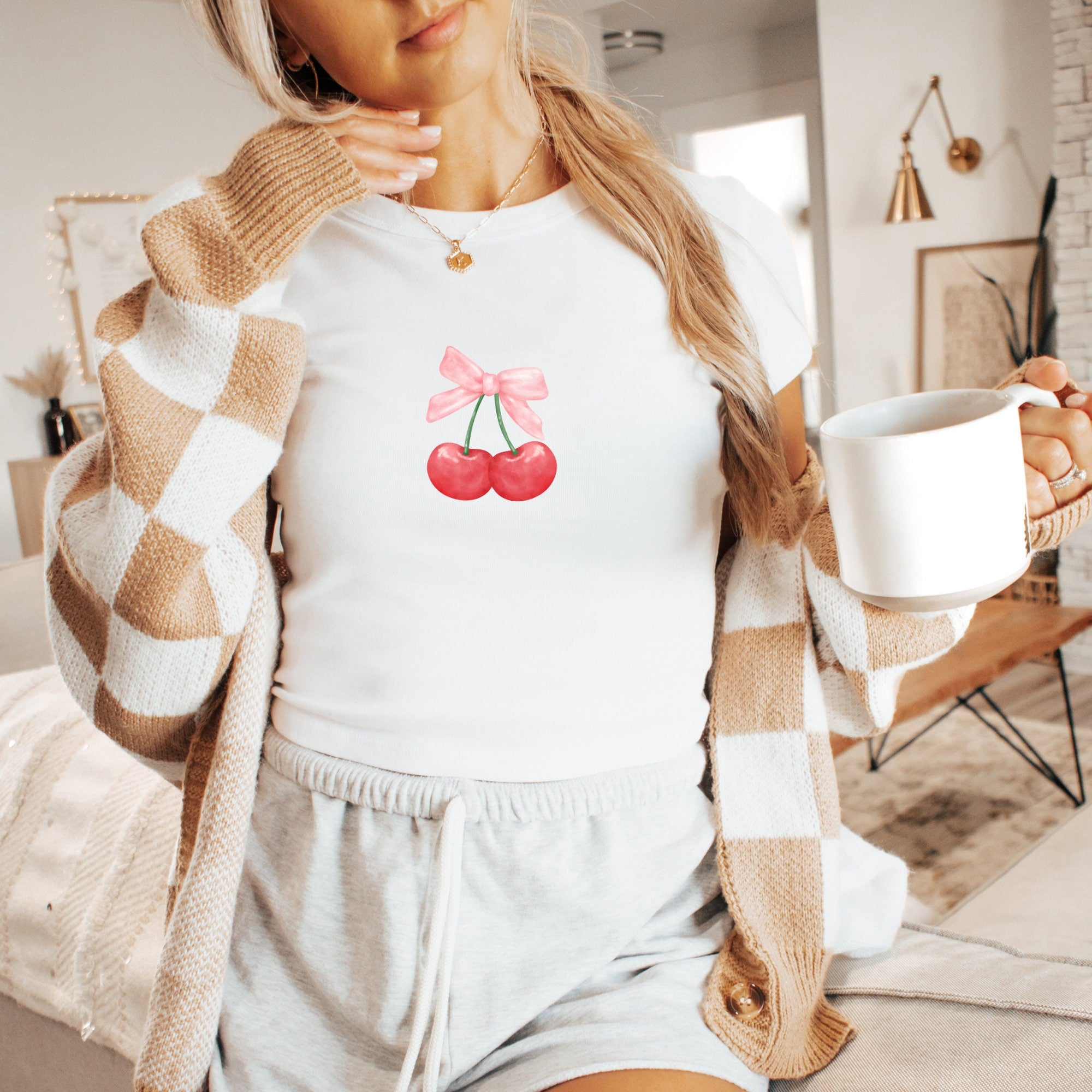 a woman is holding a cup of coffee