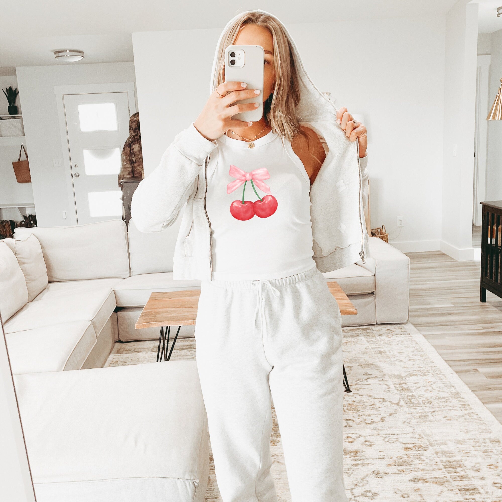 a woman taking a selfie in a living room