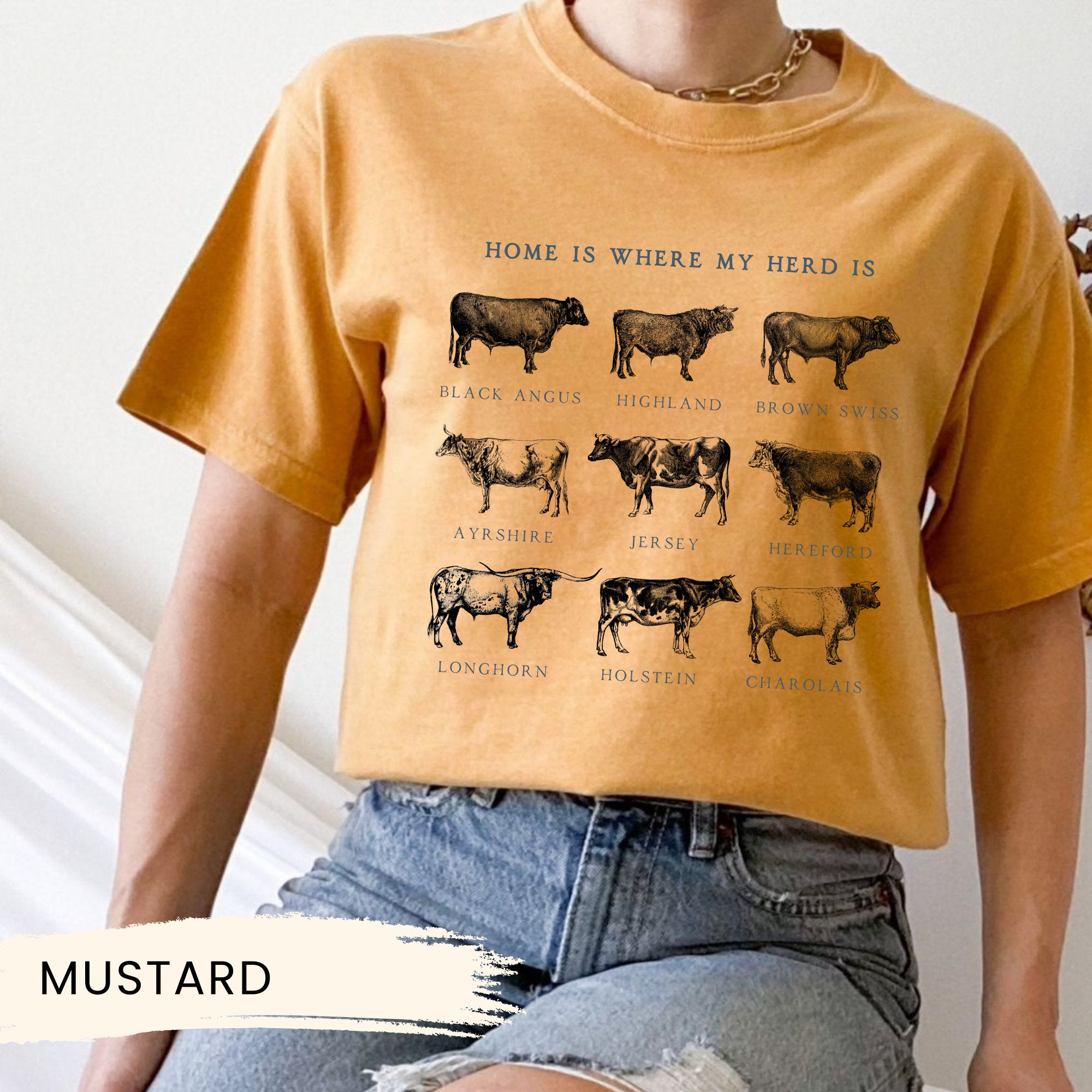 a woman wearing a mustard colored shirt with cows on it